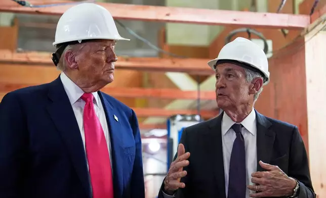 FILE - President Donald Trump listens to Federal Reserve Chairman Jerome Powell speak during a visit to the Federal Reserve, July 24, 2025, in Washington. (AP Photo/Julia Demaree Nikhinson, File)