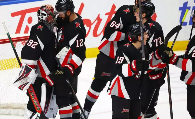 Buffalo Sabres players celebrate after a victory over the Columbus Blue Jackets in an NHL hockey game Thursday, April 9, 2026, in Buffalo, N.Y. (AP Photo/Jeffrey T. Barnes)