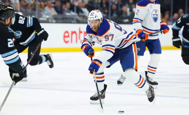 Edmonton Oilers center Connor McDavid (97) goes after the puck against the Utah Mammoth during the second period of an NHL hockey game, Tuesday, April 7, 2026, in Salt Lake City. (AP Photo/Melissa Majchrzak)