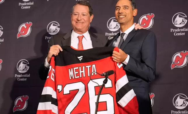 Sunny Mehta, the new general manager of the New Jersey Devils NHL hockey club, right, poses for a picture with Devils owner David Blitzer during a news conference in Newark, N.J., Tuesday, April 21, 2026. (AP Photo/Seth Wenig)