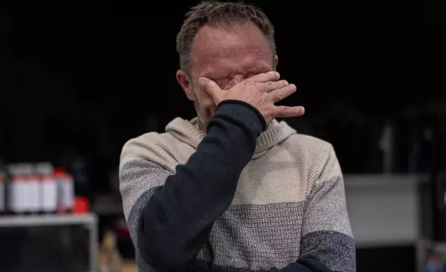 Anthony Crihfield Jones wipes tears outside his JCD Bargain and Trade store near Ripley, W.Va., Friday, March 13, 2026, as he closed his other nearby location to consolidate his businesses under one roof due to high electric bills. (AP Photo/Carolyn Kaster)