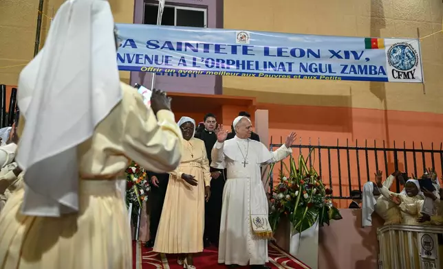 Pope Leo XIV waves to supporters as he leaves after his visit to the Ngul Zamba (Power of God) orphanage in Yaounde, Cameroon, Wednesday April 15, 2026 on the third day of his apostolic journey to Africa. (Alberto Pizzoli, Pool Photo via AP)