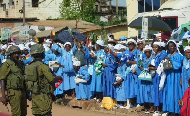 People greet Pope Leo XIV upon his arrival in Yaounde, Cameroon, Wednesday, April 15, 2026, on the third day of an 11-day apostolic journey to Africa. (AP Photo/Andrew Medichini)