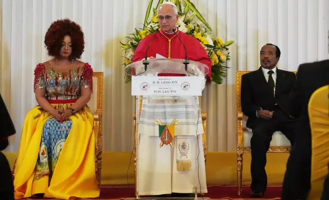 Pope Leo XIV, center, flanked by Cameroon's President Paul Biya and his wife Chantal, meets with the authorities, civil society and the diplomatic corps in Yaounde Cameroon, Wednesday, April 15, 2026. (AP Photo/Andrew Medichini)