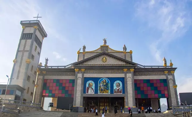 People seen at the St. Joseph Metropolitan Cathedral ahead of Pope Leo XIV's visit in Bamenda, Cameroon, Tuesday, April 14, 2026. (AP Photo/Welba Yamo Pascal)