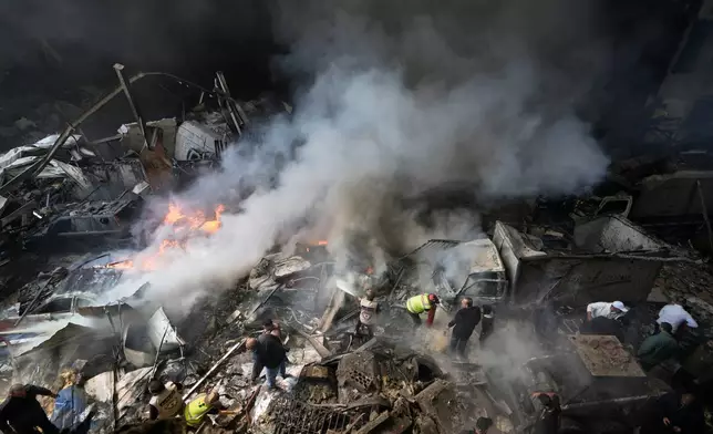 First responders search at the site of an Israeli airstrike that struck an apartment building in Beirut, Lebanon, Wednesday, April 8, 2026. (AP Photo/Bilal Hussein)