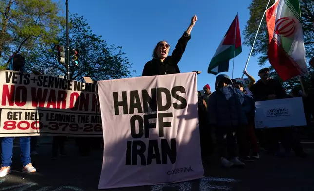 Activists protest near the White House in Washington, Tuesday evening, April 7, 2026. (AP Photo/Jose Luis Magana)