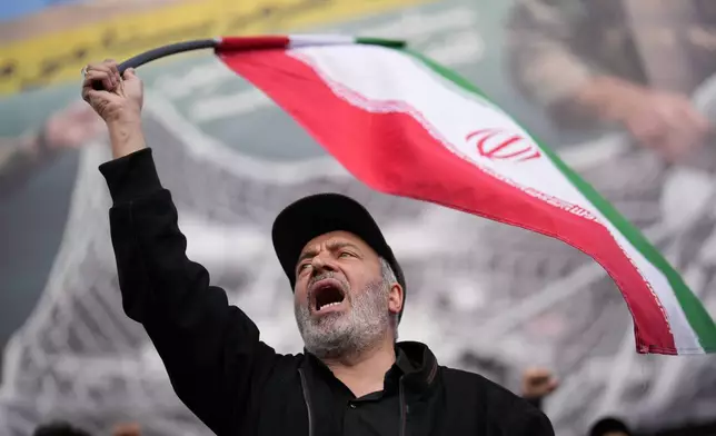 A government supporter chants slogans during a gathering after the announcement of a two-week ceasefire with the United States and Israel in Tehran, Iran, Wednesday, April 8, 2026. (AP Photo/Francisco Seco)