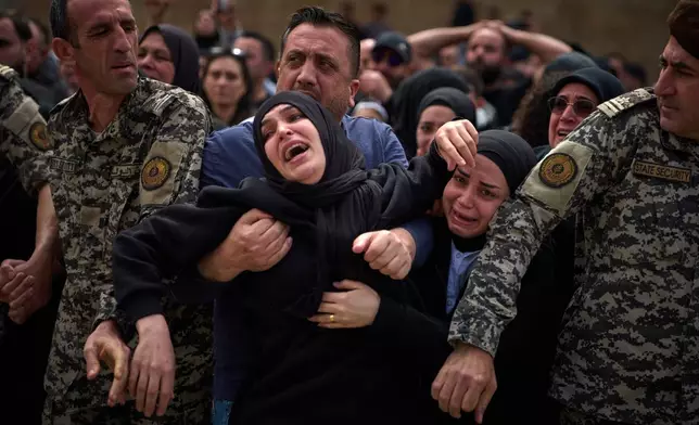 Mourners react during the funeral of 13 state security officers who were killed the previous day in an Israeli strike in Lebanon's coastal city of Sidon, Saturday, April 11, 2026. (AP Photo/Emilio Morenatti)
