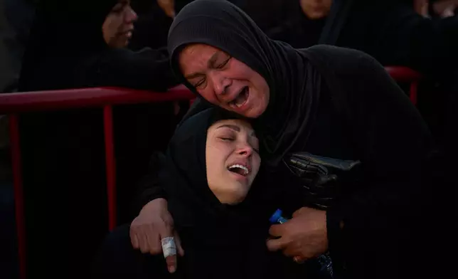 Mourners react during the funeral of 13 state security officers who were killed the previous day in an Israeli strike in Lebanon’s coastal city of Sidon, Saturday, April 11, 2026. (AP Photo/Emilio Morenatti)