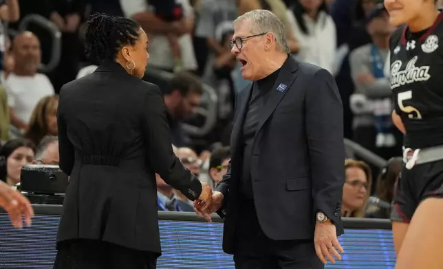 South Carolina head coach Dawn Staley, left, and UConn head coach Geno Auriemma argue after a woman's NCAA college basketball tournament semifinal game at the Final Four, Friday, April 3, 2026, in Phoenix. (AP Photo/Rick Scuteri)