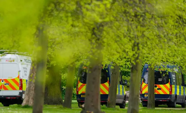 Police vehicles are parked in Kensington Gardens, near the Israeli embassy, in London, Friday April 17, 2026. (Jordan Pettitt/PA via AP)