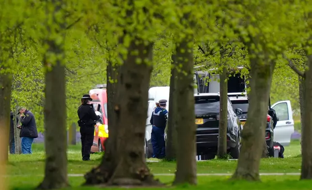 Police are seen inspecting an area in Kensington Gardens, near the Israeli Embassy, in London, Friday, April 17, 2026. (Jordan Pettitt/PA via AP)