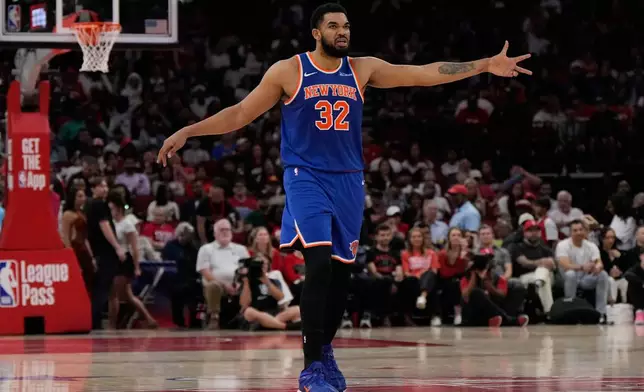 New York Knicks center Karl-Anthony Towns celebrates after a 3-pointer during the first half of an NBA basketball game against the Houston Rockets in Houston, Tuesday, March 31, 2026. (AP Photo/Ashley Landis)