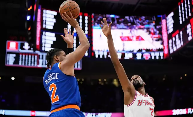 New York Knicks guard Miles McBride (2) shoots against Houston Rockets forward Kevin Durant (7) during the first half of an NBA basketball game in Houston, Tuesday, March 31, 2026. (AP Photo/Ashley Landis)