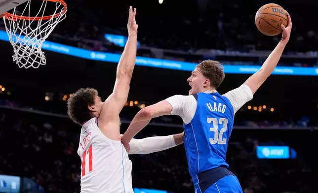 Dallas Mavericks forward Cooper Flagg, right, dunks as Los Angeles Clippers center Brook Lopez defends during the first half of an NBA basketball game Tuesday, April 7, 2026, in Inglewood, Calif. (AP Photo/Mark J. Terrill)