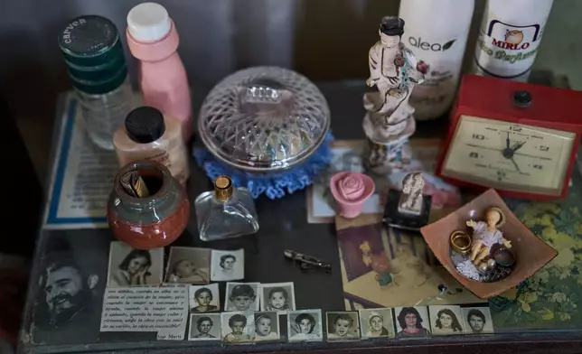 A photo of the late Cuban President Fidel Castro sits alongside photos of Mercedes Lopez Rey’s family on a bedside table at the 83-year-old’s home in Old Havana, Cuba, Wednesday, Feb. 19, 2025. (AP Photo/Ramon Espinosa)