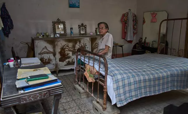 Carmen Casado, 84, sits on her bed in her home in Old Havana, Cuba, Tuesday, April 21, 2026. (AP Photo/Ramon Espinosa)