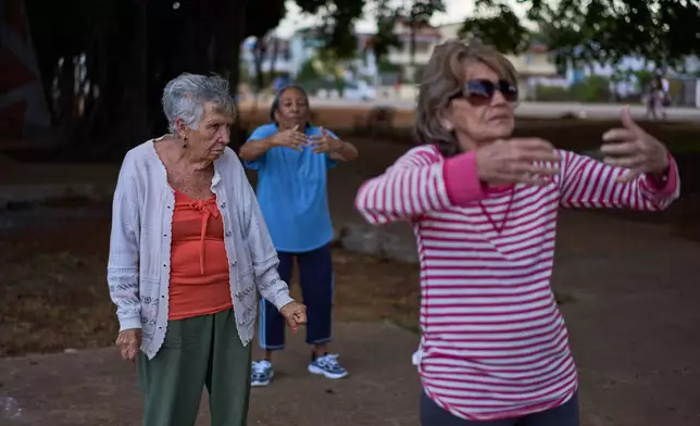 Maribel Ezcurra, 77, a retired milling machine mechanic, practices tai chi with fellow seniors in a park in the Playa neighborhood of Havana, Cuba, Wednesday, April 15, 2026. (AP Photo/Ramon Espinosa)