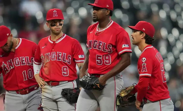 Los Angeles Angels starting pitcher José Soriano (59) gets a mound visit during the third inning of a baseball game against the Chicago White Sox, Tuesday, April 28, 2026, in Chicago. (AP Photo/Erin Hooley)