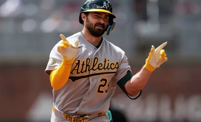 Athletics' Shea Langeliers (23) celebrates his solo home run in the fourth inning of a baseball game against the Atlanta Braves, Wednesday, April 1, 2026, in Atlanta. (AP Photo/Mike Stewart)