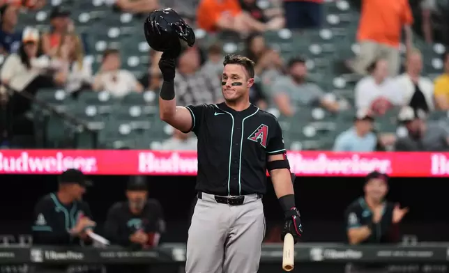 Arizona Diamondbacks' James McCann acknowledges the crowd during the second inning of a baseball game against the Baltimore Orioles, Tuesday, April 14, 2026, in Baltimore. (AP Photo/Stephanie Scarbrough)