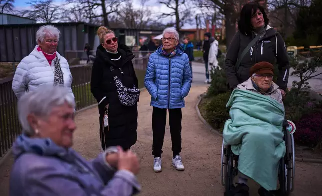 Christel Krueger, center right, attends a guided tour for people with dementia organized by Malteser Deutschland, part of the international Catholic aid organization Malteser Order of Malta, at the Zoo in Berlin, Germany, Thursday, March 26, 2026. (AP Photo/Markus Schreiber)