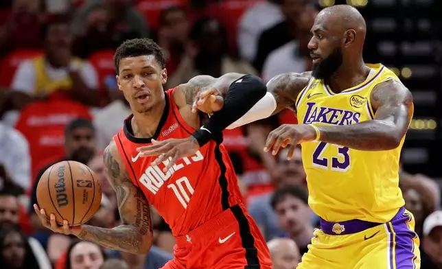 Houston Rockets forward Jabari Smith Jr. (10) becomes entangled with Los Angeles Lakers forward LeBron James (23) as he drives to the basket during the first half of Game 3 in a first-round NBA playoffs basketball series Friday April 24, 2026, in Houston. (AP Photo/Michael Wyke)