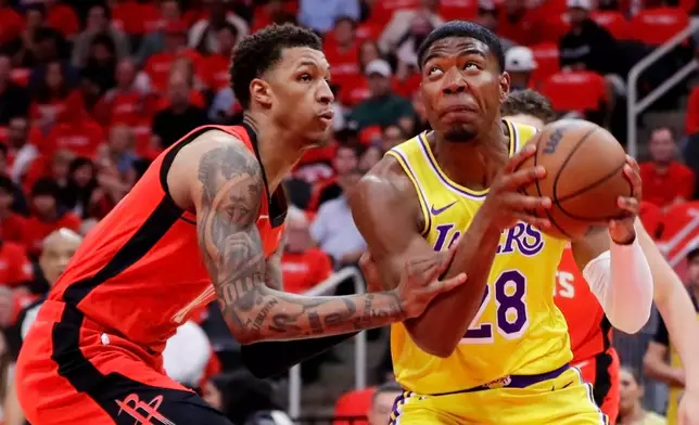 Los Angeles Lakers forward Rui Hachimura, right, looks to shoot while under pressure from Houston Rockets forward Jabari Smith Jr., left, during the first half of Game 3 in a first-round NBA playoffs basketball series Friday April 24, 2026, in Houston. (AP Photo/Michael Wyke)