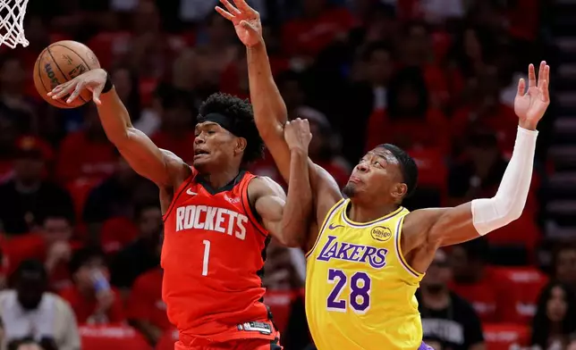 Houston Rockets guard Amen Thompson (1) loses a rebound in front of Los Angeles Lakers forward Rui Hachimura (28) during the first half in Game 3 of a first-round NBA playoffs basketball series Friday April 24, 2026, in Houston. (AP Photo/Michael Wyke)