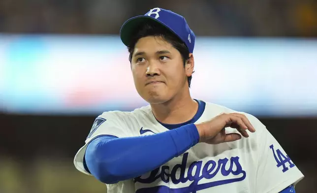 Los Angeles Dodgers starting pitcher Shohei Ohtani walks toward the dugout after the fourth inning of a baseball game against the New York Mets Wednesday, April 15, 2026, in Los Angeles. (AP Photo/Jae C. Hong)