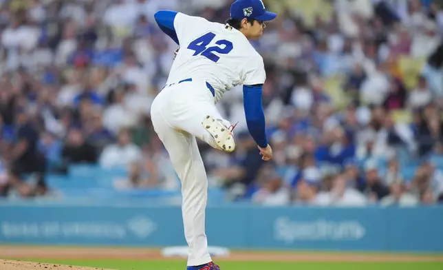 Los Angeles Dodgers starting pitcher Shohei Ohtani follows through on his pitch against the New York Mets during the first inning of a baseball game Wednesday, April 15, 2026, in Los Angeles. (AP Photo/Jae C. Hong)