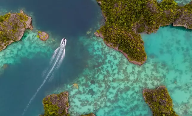A speedboat crosses the Waigeo Barat islands, Raja Ampat, Indonesia, Thursday, March 5, 2026. (AP Photo/Claudia Rosel)