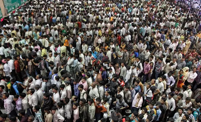 FILE - Indians crowd ticket counters at a railway station in Ahmadabad, India, Oct. 23, 2011. (AP Photo/Ajit Solanki, File)