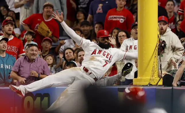 Los Angeles Angels left fielder Jo Adell (7) catches a ball hit by Seattle Mariners' J.P. Crawford during the ninth inning of a baseball game Saturday, April 4, 2026, in Anaheim, Calif. (AP Photo/Caroline Brehman)