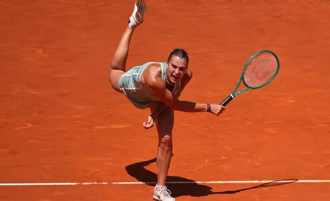 Aryna Sabalenka of Belarus serves the ball to Naomi Osaka of Japan during the Madrid Open tennis tournament in Madrid, Monday, April 27, 2026. (AP Photo/Manu Fernandez)