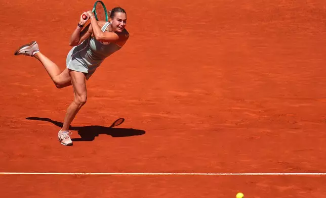 Aryna Sabalenka of Belarus returns the ball to Naomi Osaka of Japan during the Madrid Open tennis tournament in Madrid, Monday, April 27, 2026. (AP Photo/Manu Fernandez)