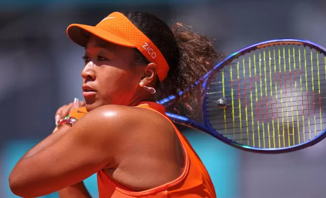Naomi Osaka of Japan returns the ball to Aryna Sabalenka of Belarus during the Madrid Open tennis tournament in Madrid, Monday, April 27, 2026. (AP Photo/Manu Fernandez)