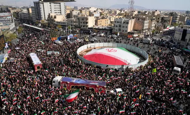 Mourners gather during a funeral procession for Alireza Tangsiri, head of Iran's Islamic Revolutionary Guard Corps Navy, and others killed in Israeli strikes in late March, in Tehran, Iran, Wednesday, April 1, 2026. (AP Photo/Vahid Salemi)