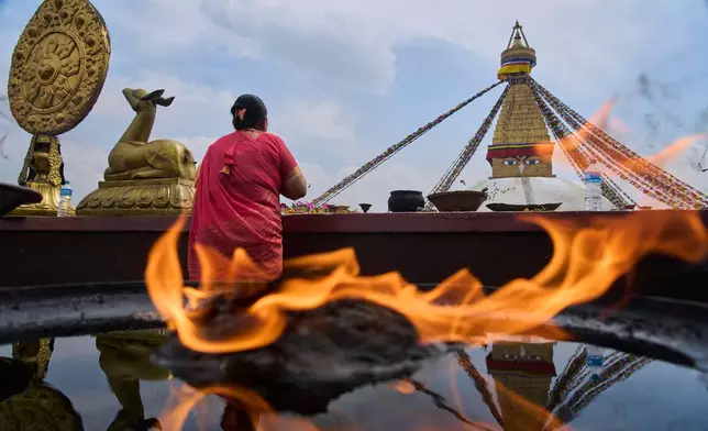 A Tamang community woman pays homage to her deceased loved ones during the Temal festival at Boudhanath Stupa in Kathmandu, Nepal, Wednesday, April 1, 2026.(AP Photo/Niranjan Shrestha)