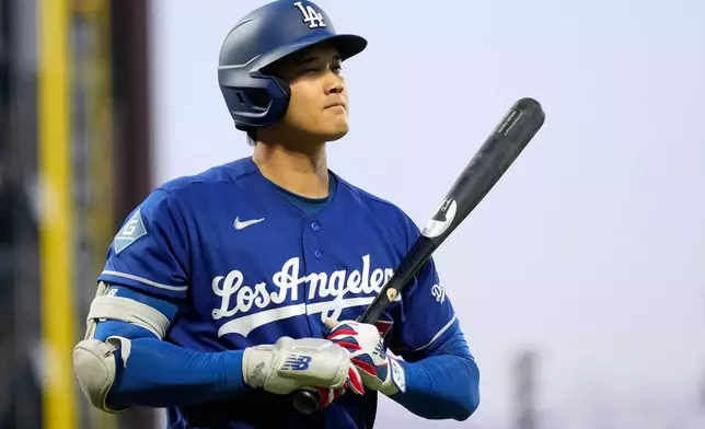 Los Angeles Dodgers' Shohei Ohtani walks to the dugout after striking out during the fifth inning of a baseball game against the San Francisco Giants, Wednesday, April 22, 2026, in San Francisco. (AP Photo/Tony Avelar)
