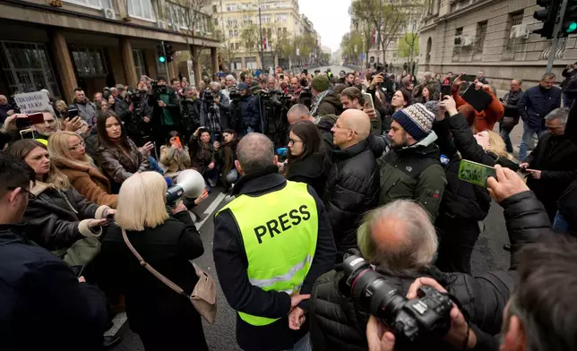 Serbian journalists block the traffic outside the offices of Serbia's President Aleksandar Vucic in Belgrade, Serbia, Wednesday, April 1, 2026, in protest of mounting attacks and pressure on the media. (AP Photo/Darko Vojinovic)