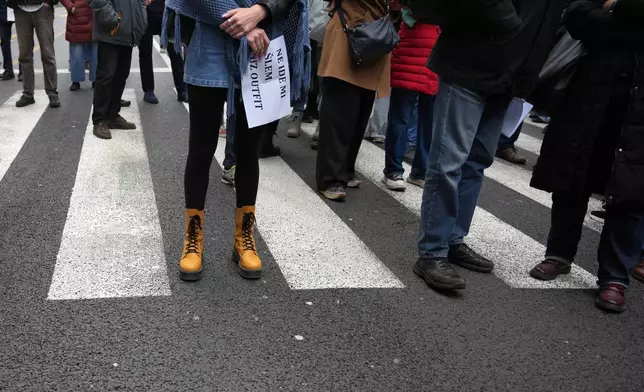 Serbian journalists block the traffic outside the offices of Serbia's President Aleksandar Vucic in Belgrade, Serbia, Wednesday, April 1, 2026, in protest of mounting attacks and pressure on the media. (AP Photo/Darko Vojinovic)