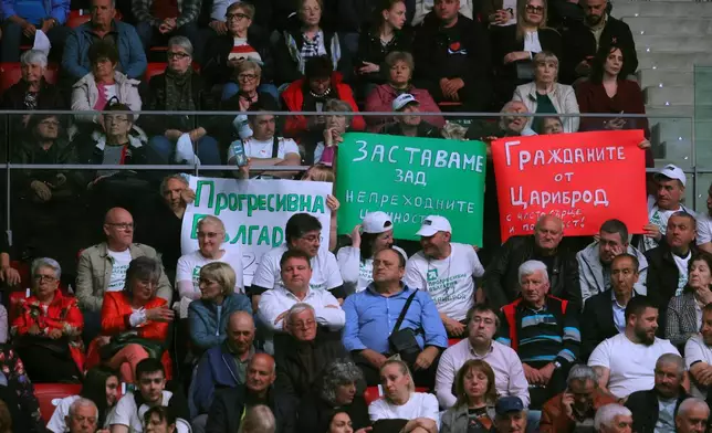 Supporters of former Bulgarian President Rumen Radev hold posters in the colors of the Bulgarian flag during the closing rally of his campaign, in Sofia, Thursday, April 16, 2026, as Bulgaria heads into an early parliamentary election. (AP Photo/Valentina Petrova)
