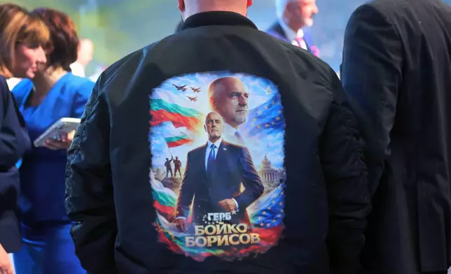 A print on the back of a jacket of a supporter depicts the former three-time conservative Prime Minister Boyko Borissov at the closing rally of his campaign, in Samokov, Wednesday, April 15, 2026, as Bulgaria heads into an early parliamentary election. (AP Photo/Valentina Petrova)