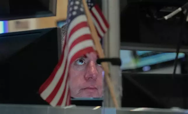 Trader Justin Flinn works on the floor of the New York Stock Exchange, Thursday, April 23, 2026. (AP Photo/Richard Drew)