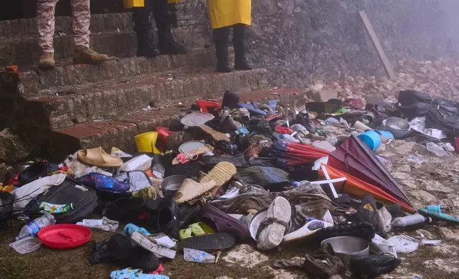 The shoes of victims of a deadly stampede sit by the main entrance of the Citadelle Laferriere in Milot, Haiti, Sunday, April 12, 2026. (AP Photo/Ketlain Difficile)