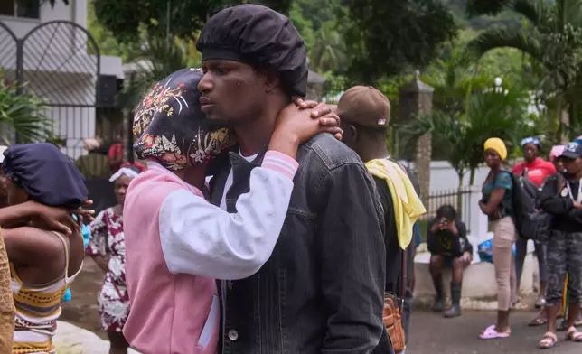 Relatives of a victim of a deadly stampede react in Milot, Haiti, Sunday, April 12, 2026. (AP Photo/Ketlain Difficile)
