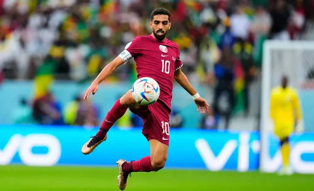 FILE - Qatar's Hassan Al-Haydos controls the ball during a World Cup group A soccer match against Senegal at the Al Thumama Stadium in Doha, Qatar, Friday, Nov. 25, 2022. (AP Photo/Petr Josek, File)