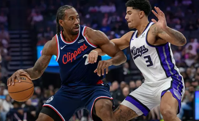 Los Angeles Clippers forward Kawhi Leonard (2) is guarded by Sacramento Kings guard Killian Hayes (3) during the first half of an NBA basketball game in Sacramento, Calif., Sunday, April 5, 2026. (AP Photo/Randall Benton)